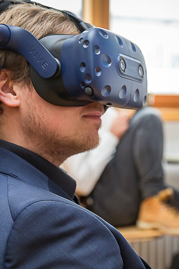 [Translate to English:] Studierender mit VR-Brille während eines Projektes zum virtuellem Fahren